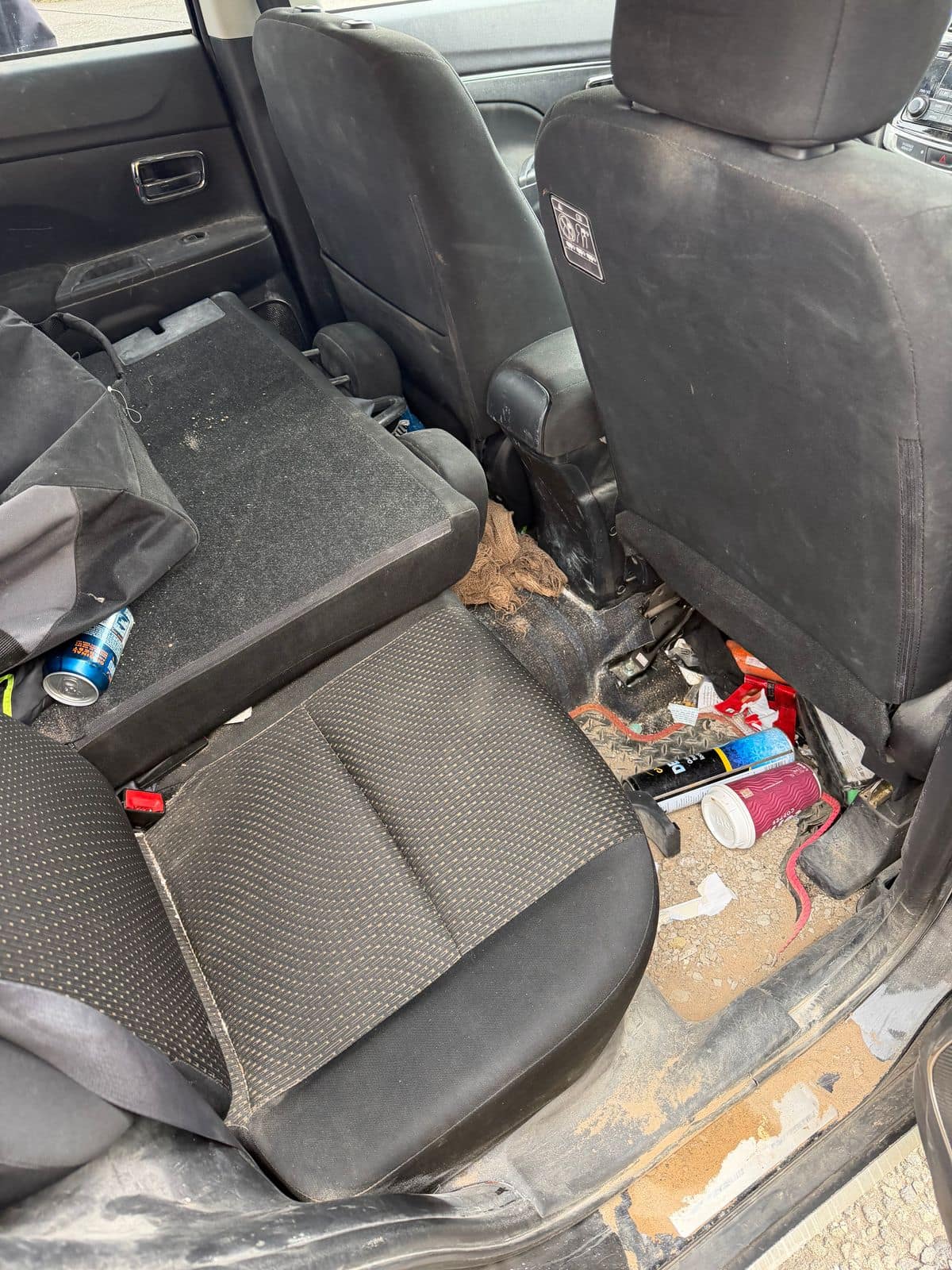 Before: rear seats and footwell full of rubbish