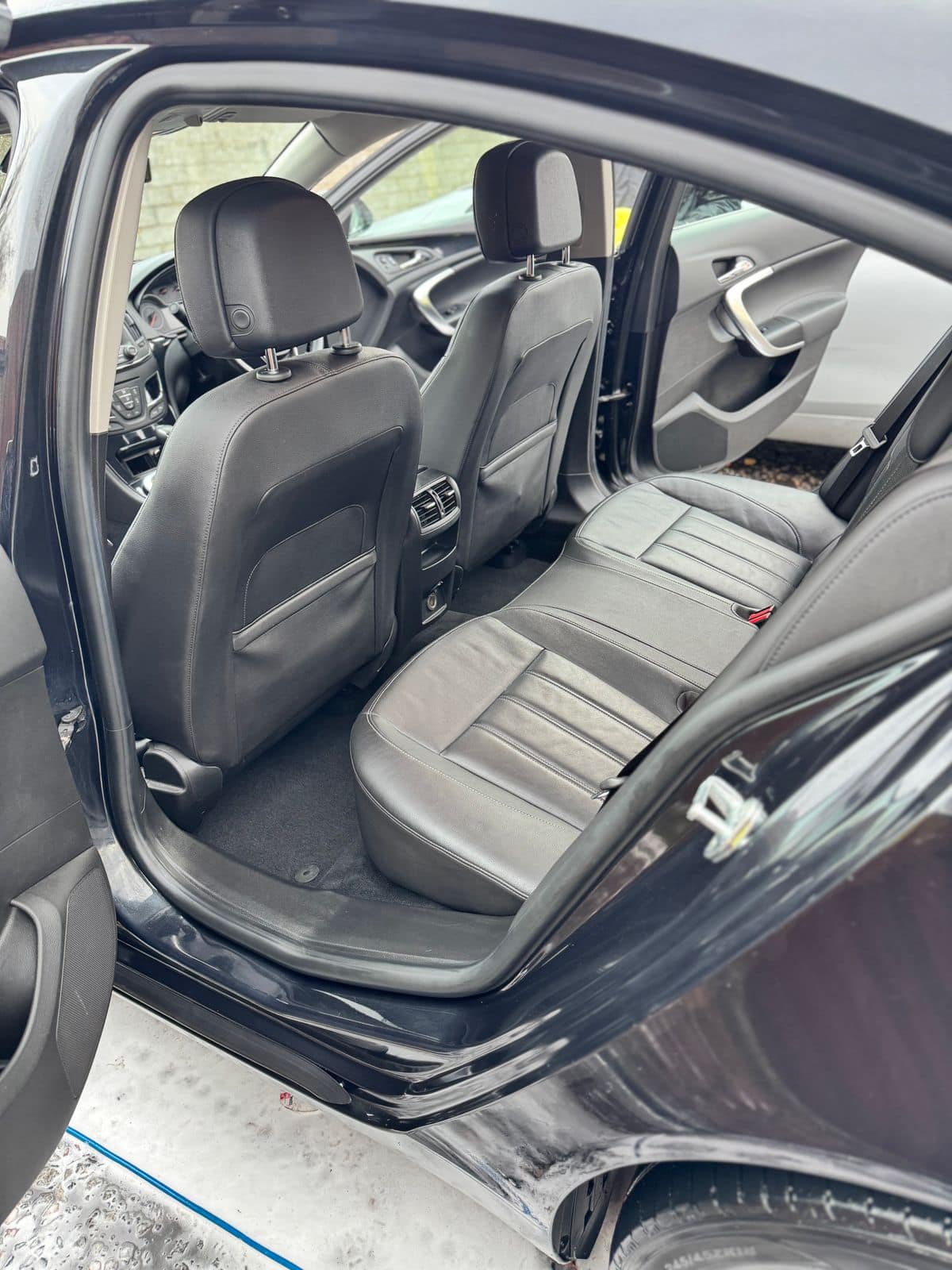 After: the same rear seats clean, with spotless leather