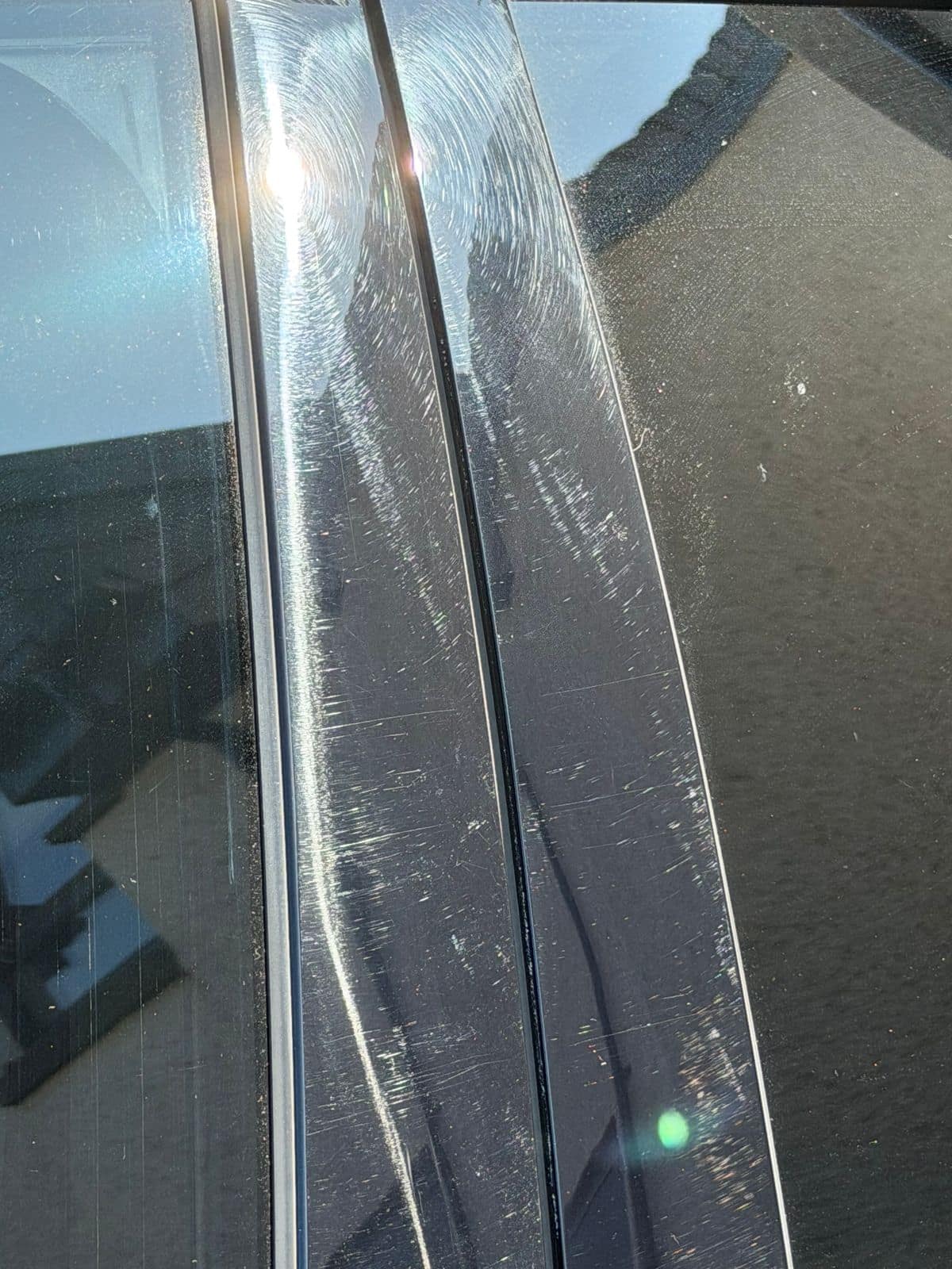 Before: gloss-black door pillar covered in fine scratches
